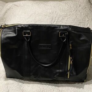 Sleek Black Travel Bag with Gold Accents